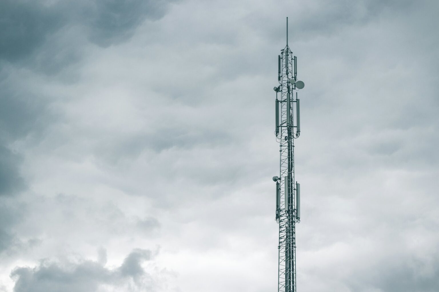 Communications tower against a cloudy sky